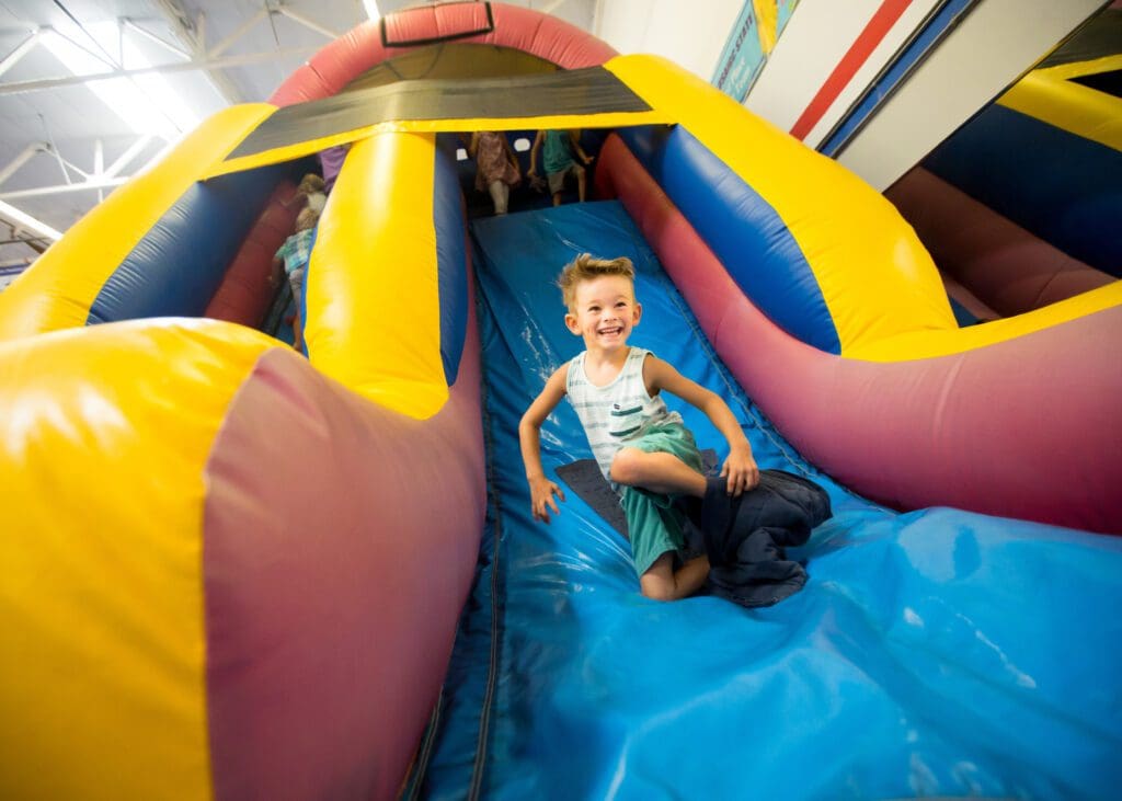 A boy having fun at an inflatable slide